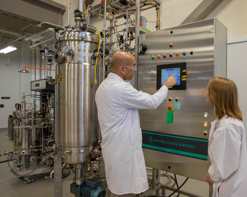 Dr. Vijay demonstrates fermentation equipment at the Integrated Bioprocessing Research Laboratory